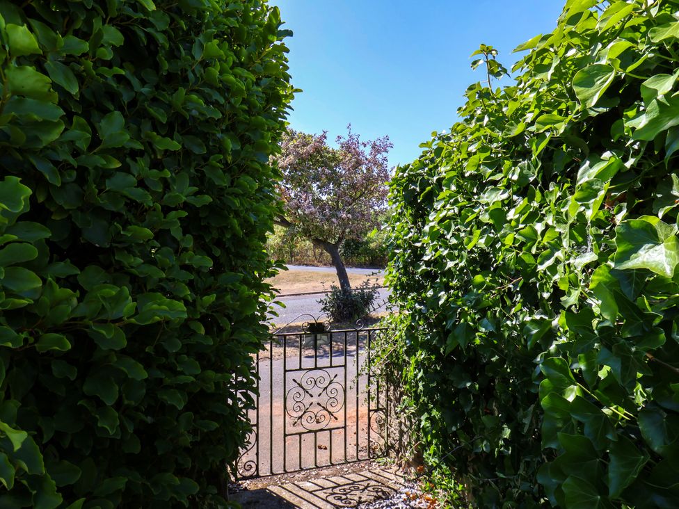 A view of a garden gate surrounded by hedges at Seacrest Lodge in Scarborough