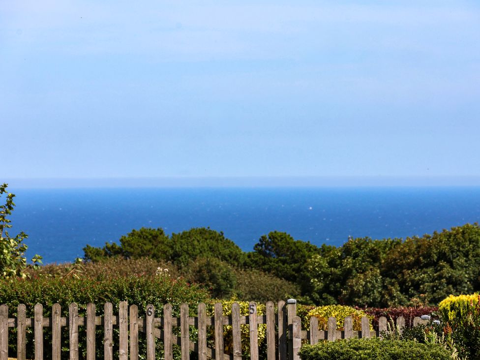 An ocean view with a wooden fence and plants at Seacrest Lodge Scarborough