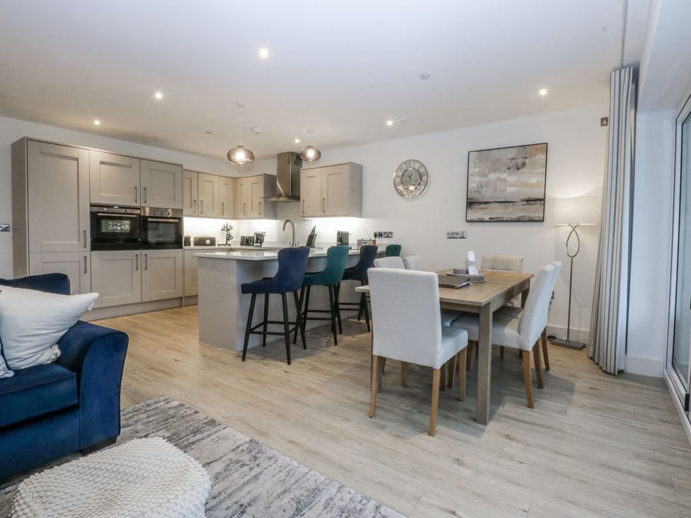 A kitchen with a dining area and seating at Estuary View in Colwyn Bay