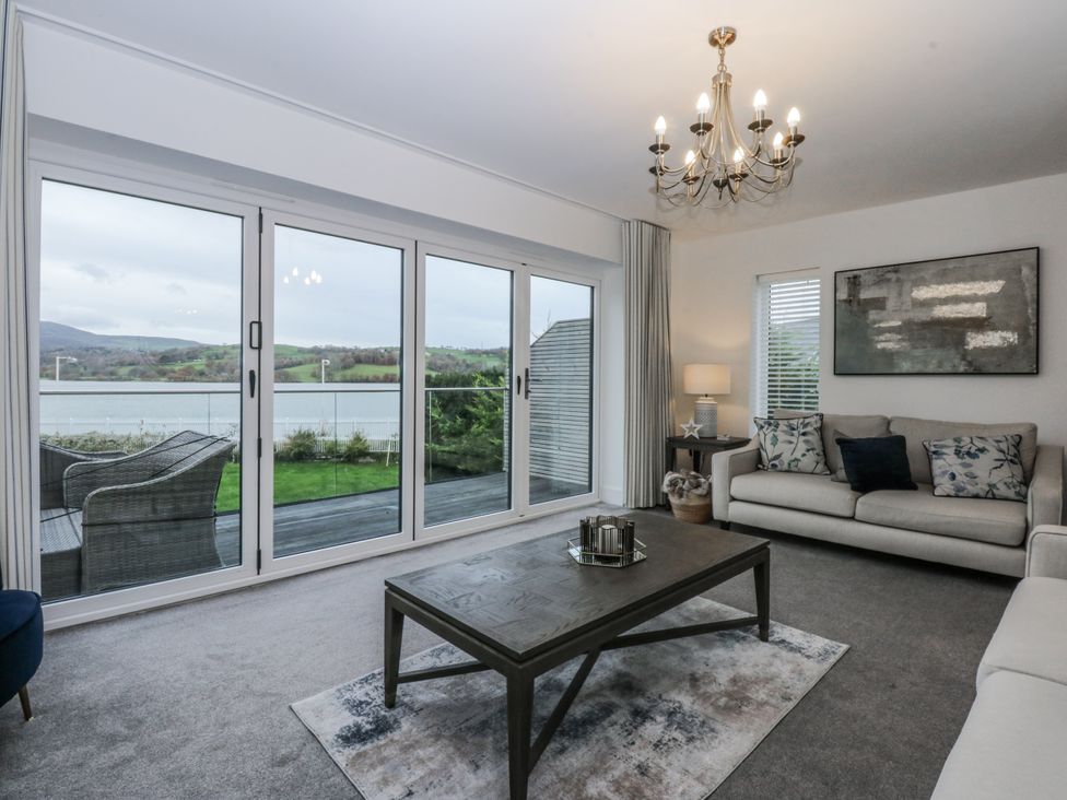 A living room with a sofa and coffee table at Estuary View in Colwyn Bay