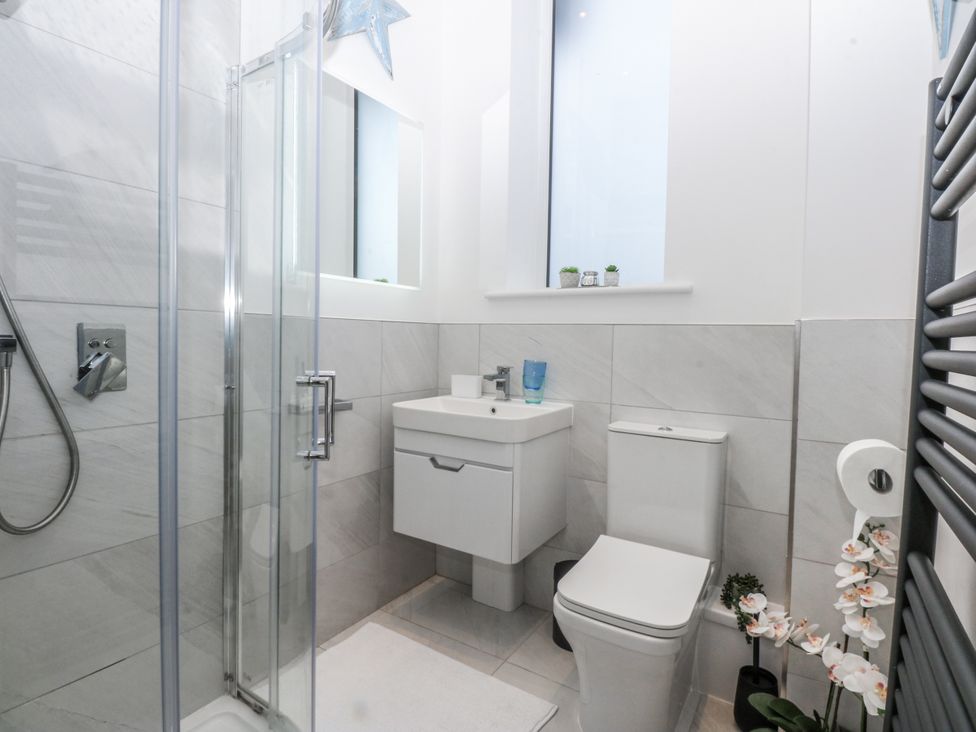 A bathroom with shower and sink at Estuary View in Colwyn Bay