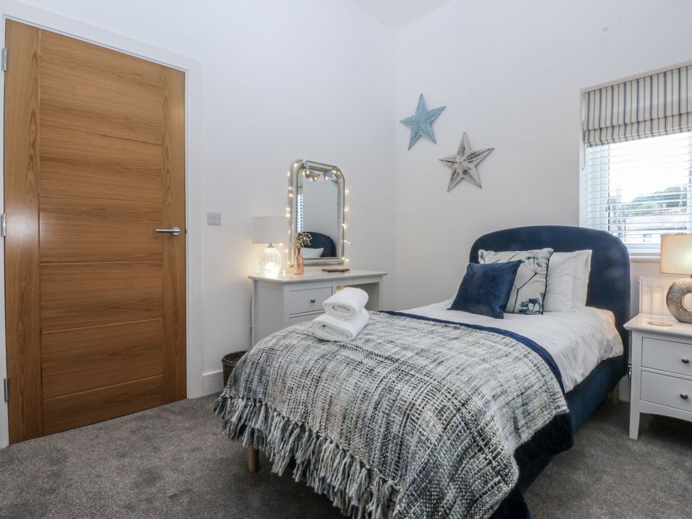 A bedroom with a bed and bedside table at Estuary View in Colwyn Bay