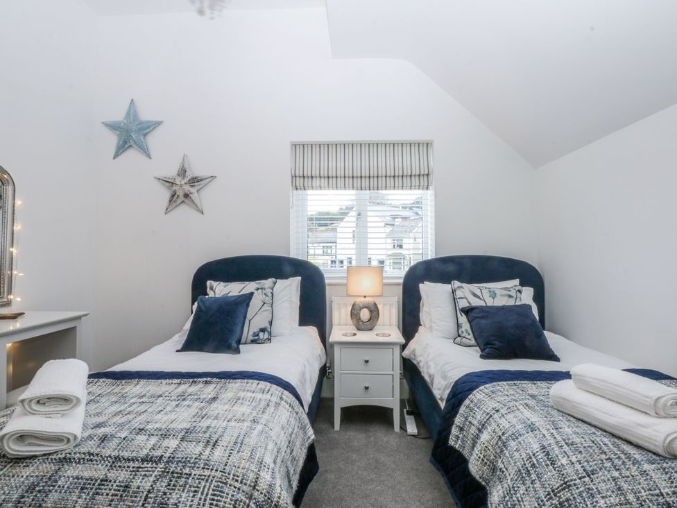 A bedroom with two beds and a window at Estuary View in Colwyn Bay