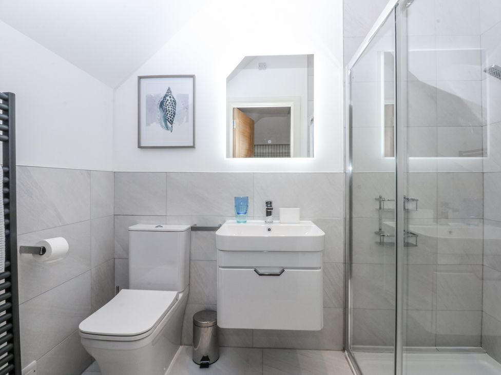 A bathroom with a shower and sink at Estuary View Colwyn Bay