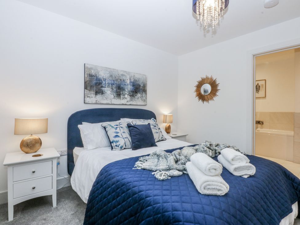 A bedroom with a bed and nightstand at Estuary View in Colwyn Bay