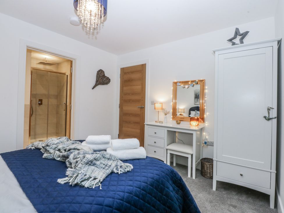 A bedroom with a bed and wardrobe at Estuary View in Colwyn Bay
