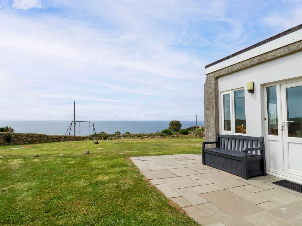 An outdoor area with a bench and swing set at Kitticarn Sennen Cove near St Just