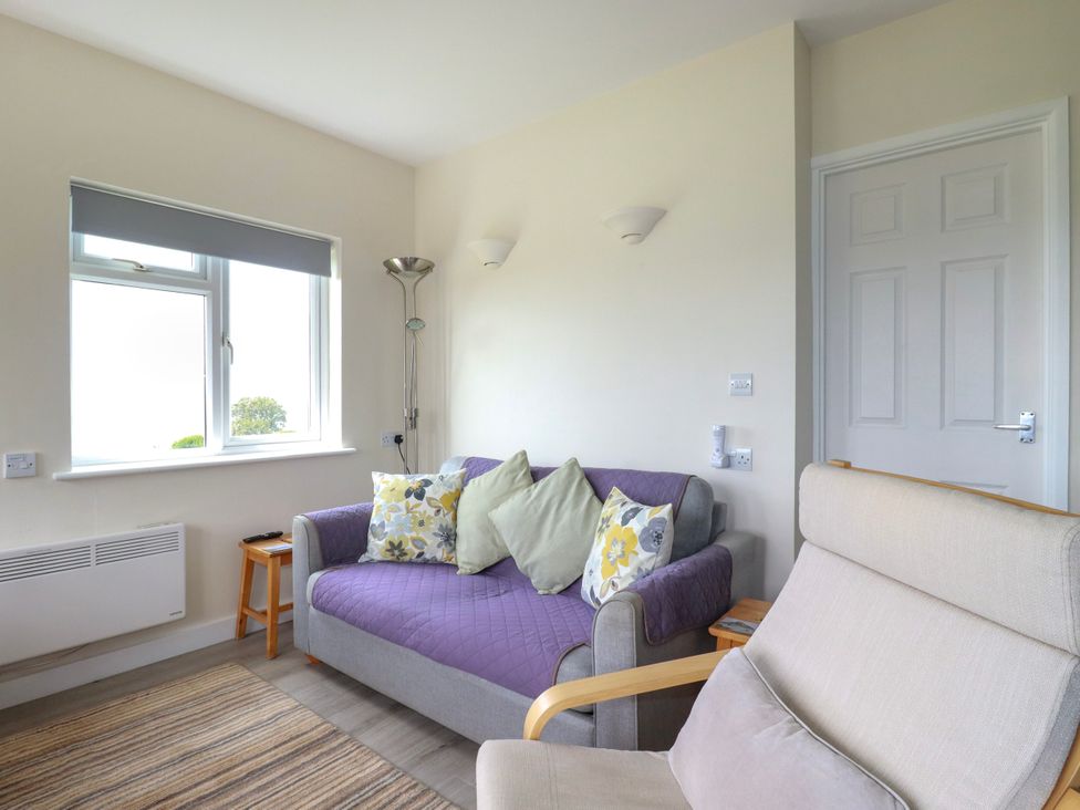 A living room with a sofa and cushions at Kitticarn Sennen Cove near St Just