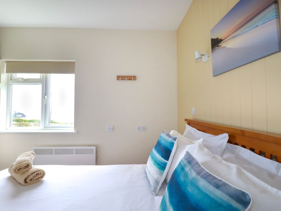 A bedroom with bed pillows and towels at Kitticarn in Sennen Cove near St Just