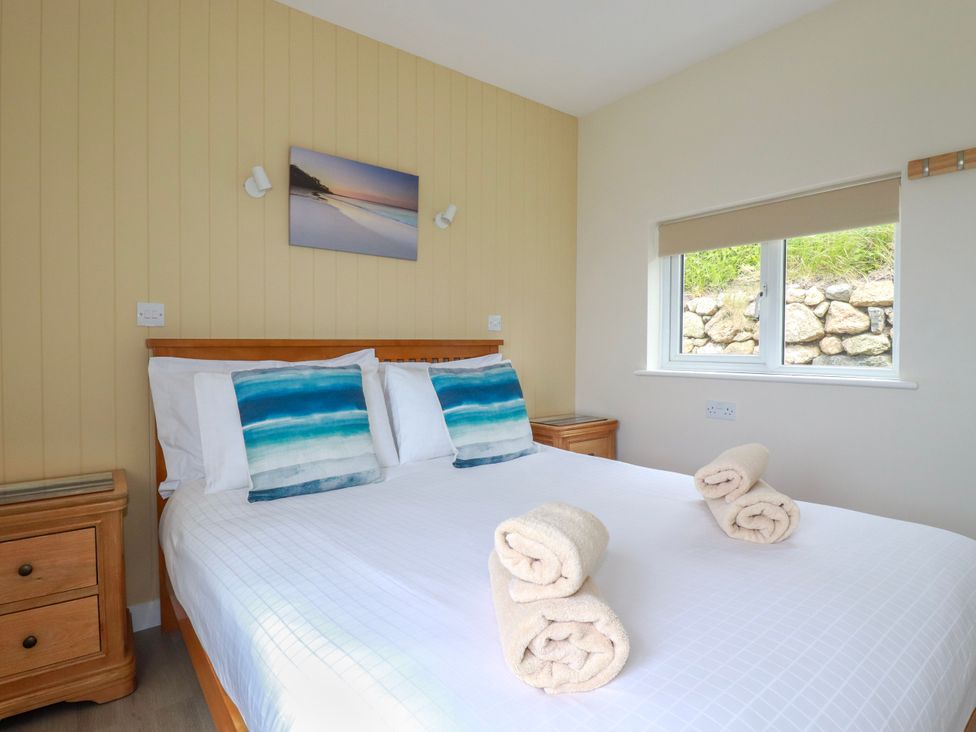 A bedroom with a bed and bedside tables at Kitticarn in Sennen Cove near St Just