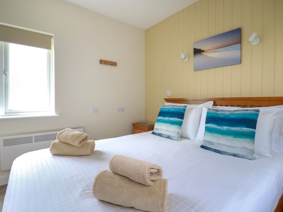 A bedroom with a double bed and towels at Kitticarn Sennen Cove near St Just