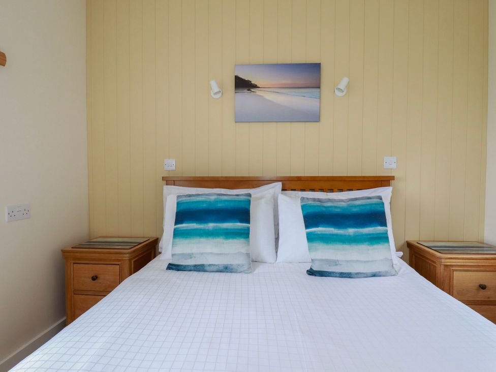 A bedroom with a bed and bedside tables at Kitticarn in Sennen Cove near St Just