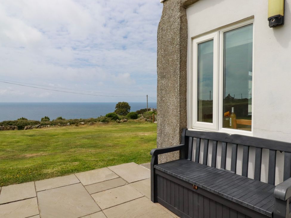 A bench and window overlooking the sea at Kitticarn in Sennen Cove near St Just