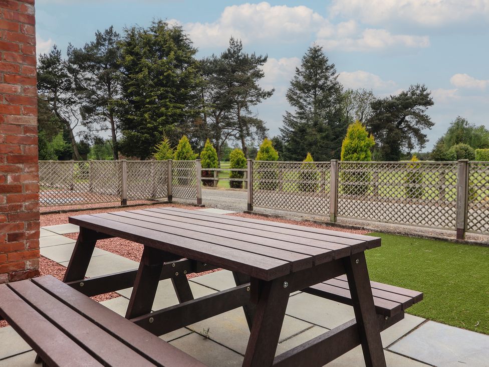 An outdoor area with a picnic table and grass at The Paddock in York