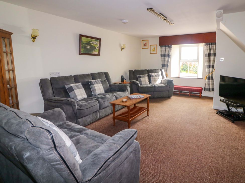 A living room with sofas and a coffee table at Curradoon House in Touraneena, County Waterford