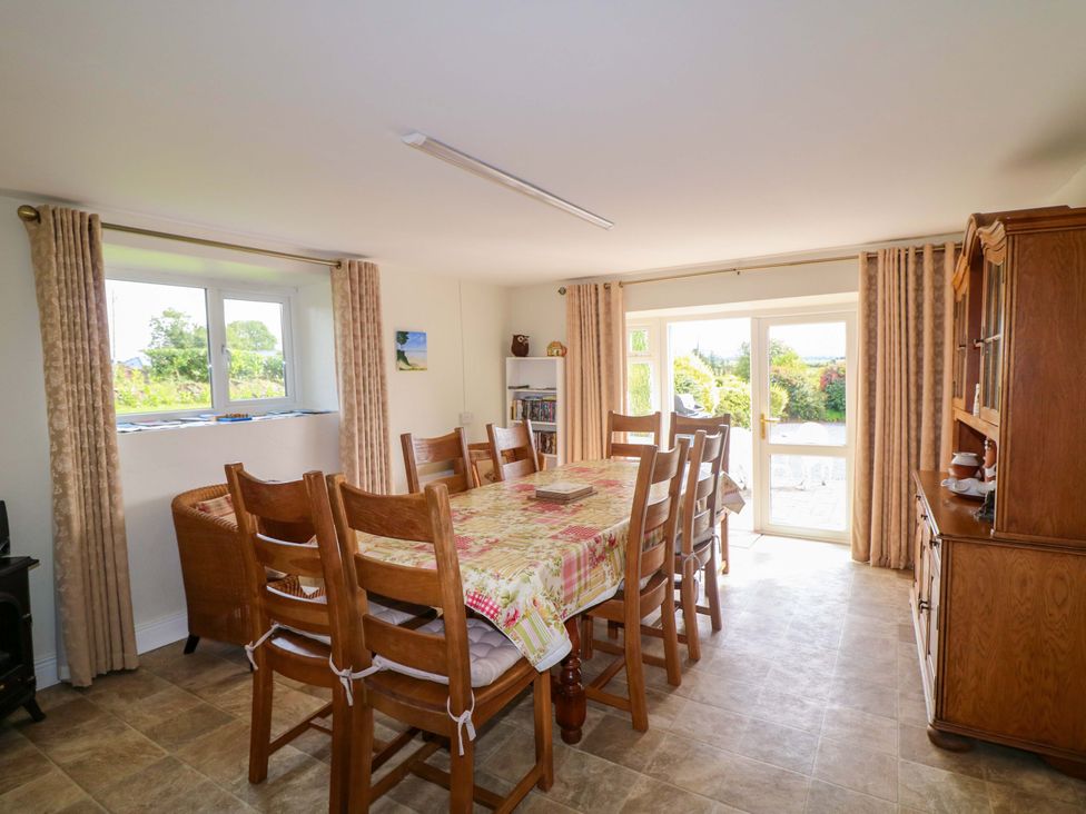 A dining room with a table and chairs at Curradoon House in Touraneena, County Waterford