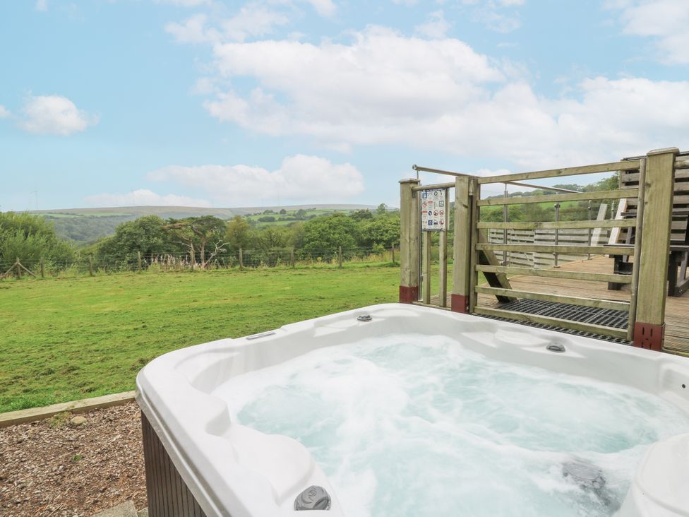 An outdoor hot tub with a view of the landscape at The Cabin in Pontardawe