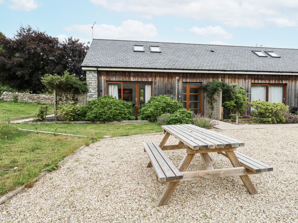 An outdoor table and bench near a house at Budmouth in Upwey near Weymouth