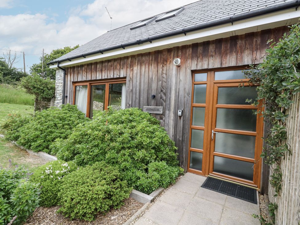 A house with a wooden exterior and pathway at Budmouth Upwey near Weymouth
