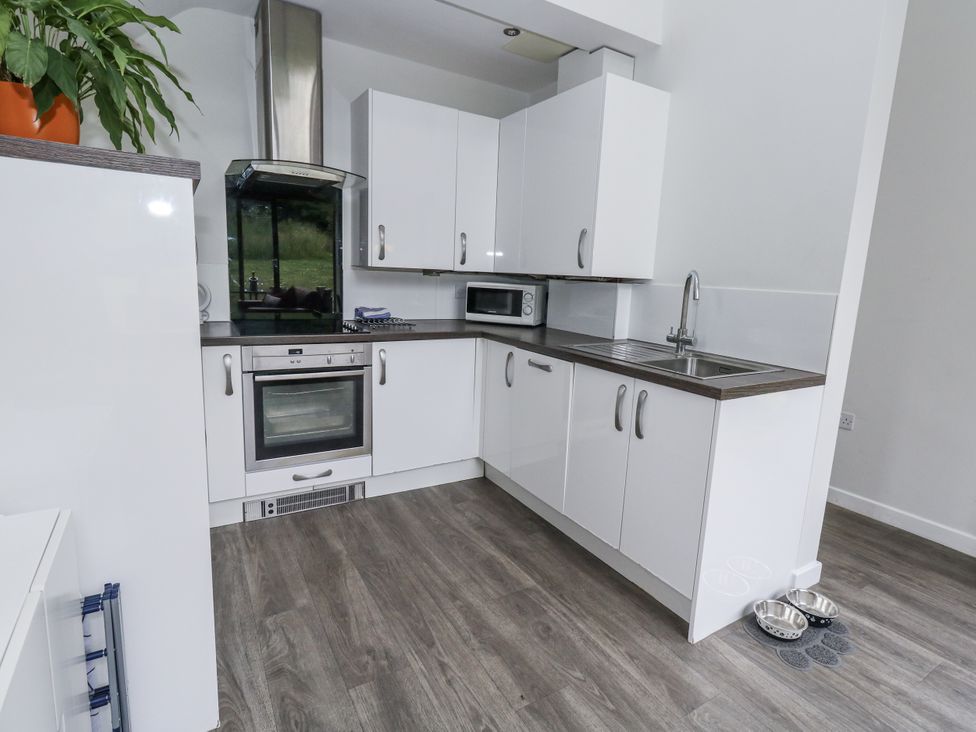 A kitchen with cabinets and appliances at Budmouth in Upwey near Weymouth