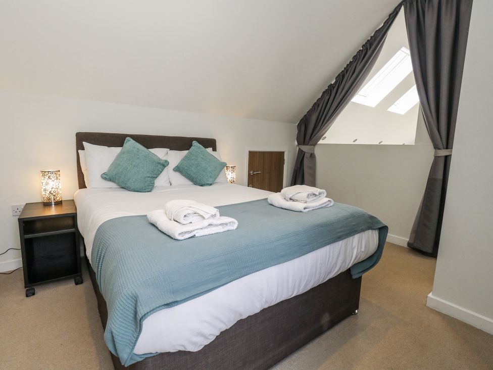 A bedroom with a bed and bedside table at Budmouth in Upwey near Weymouth