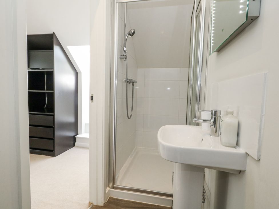 A bathroom with a shower and sink at Budmouth Upwey near Weymouth