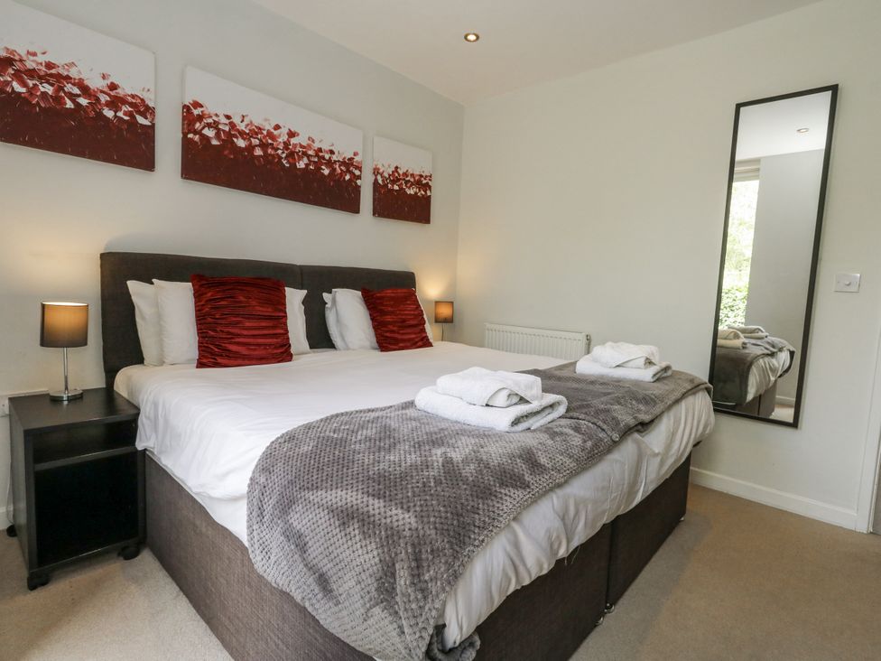 A bedroom with a bed and bedside table at Budmouth in Upwey near Weymouth
