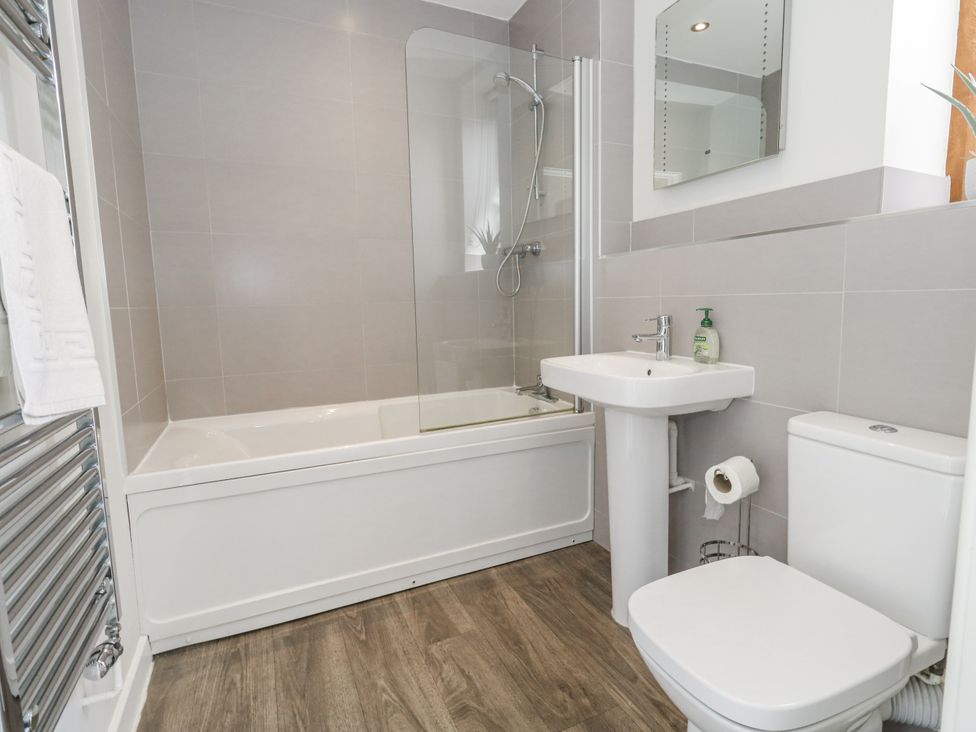 A bathroom with a bathtub, shower, sink, and toilet at Budmouth in Upwey near Weymouth