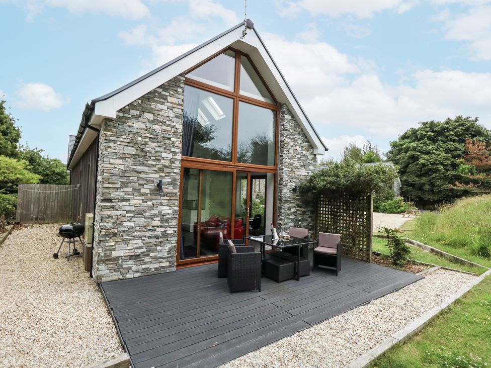 An outdoor area with seating and grill at Budmouth Upwey near Weymouth