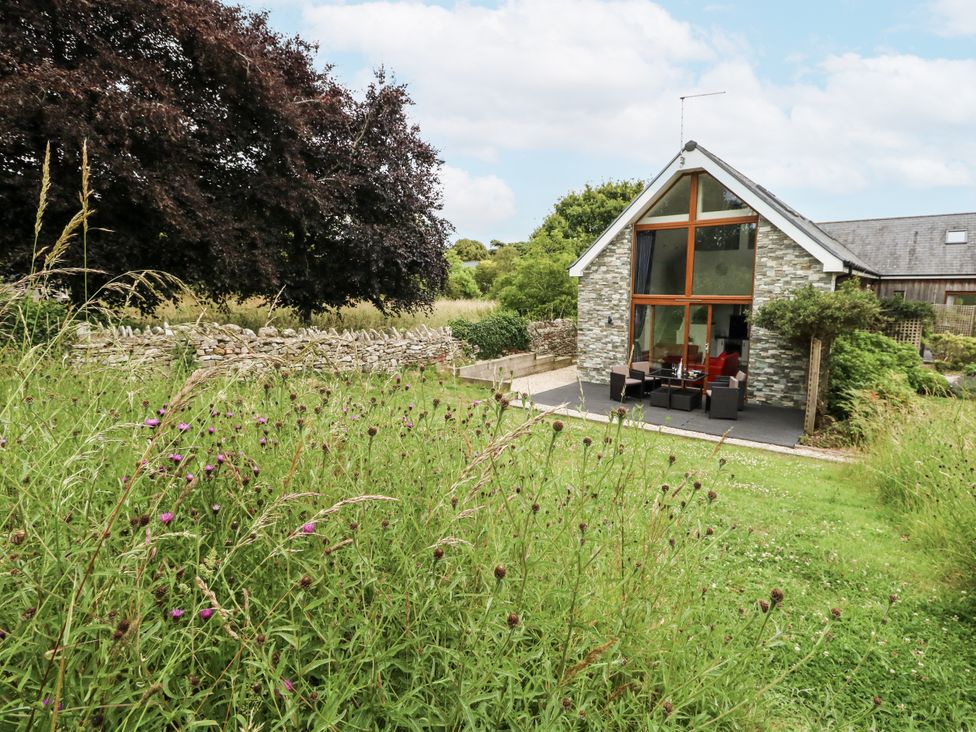 A house with a patio and chairs at Budmouth in Upwey near Weymouth