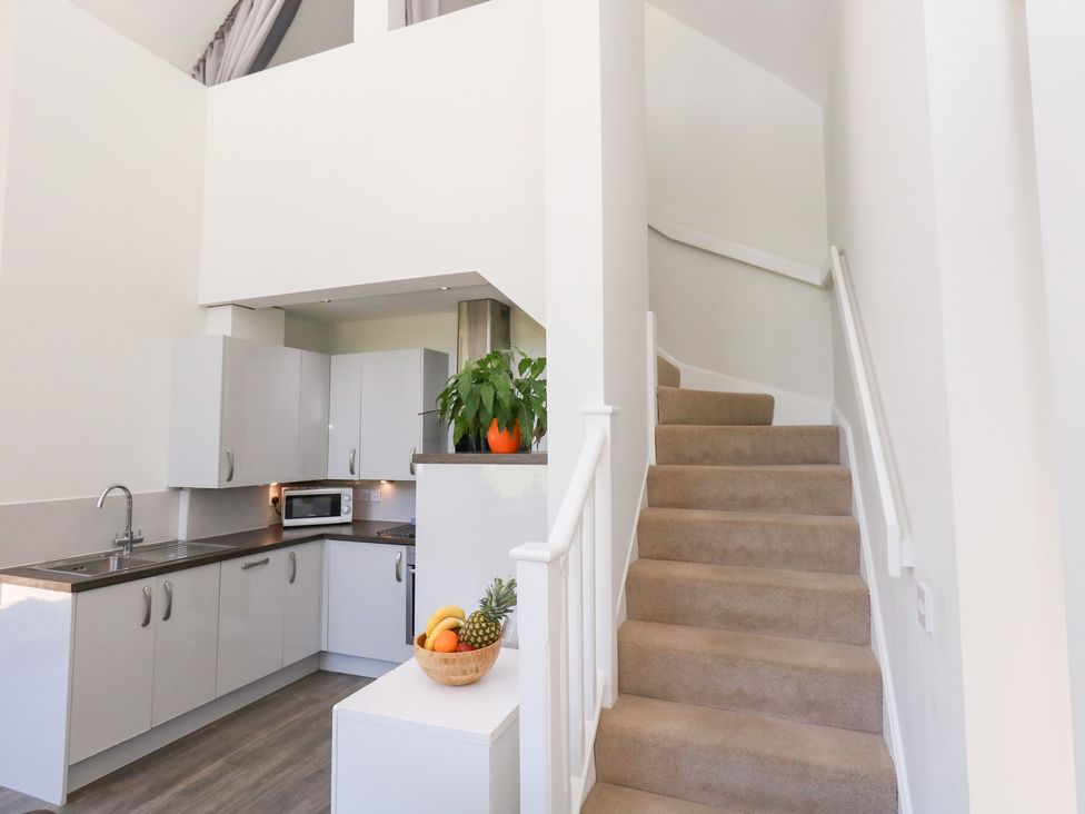 A kitchen with a staircase at Shepherd Oak in Upwey near Weymouth