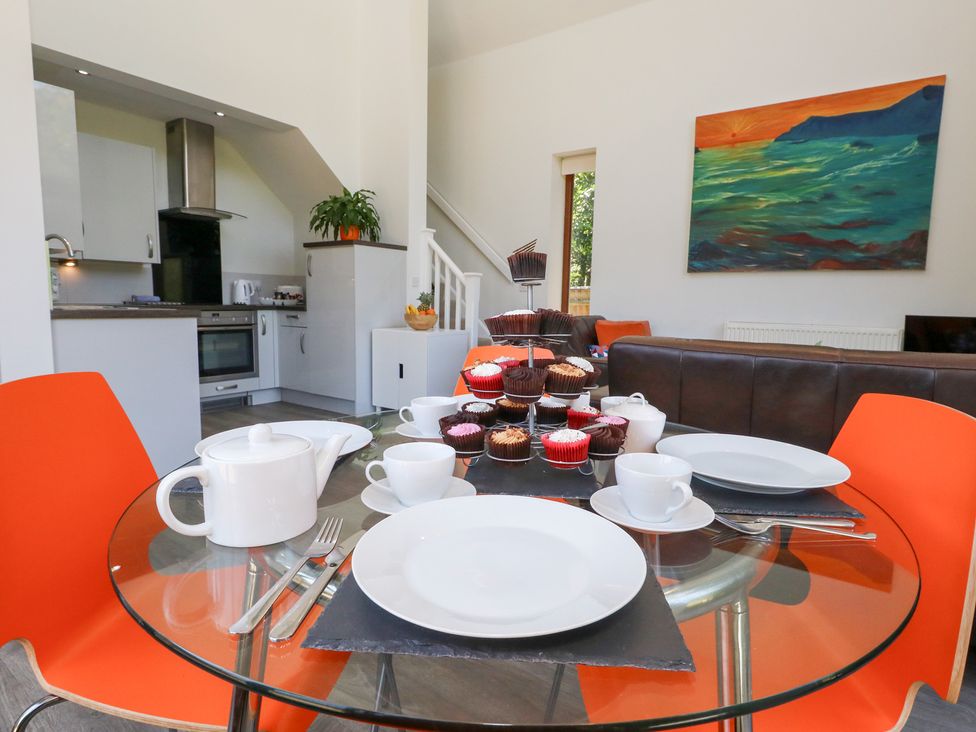 A dining room with cupcakes and a teapot at Shepherd Oak in Upwey near Weymouth