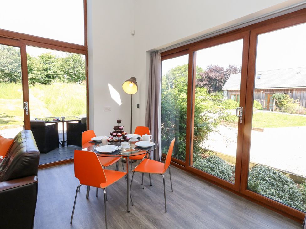A dining area with a table and chairs at Shepherd Oak in Upwey near Weymouth
