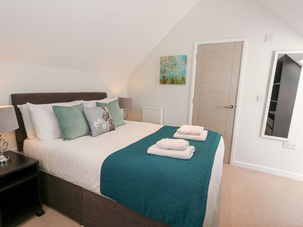 A bedroom with a bed and towels at Shepherd Oak Upwey near Weymouth