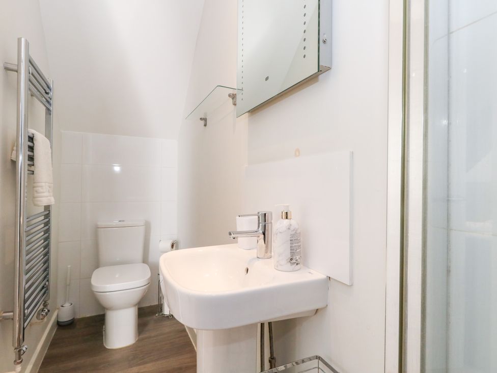 A bathroom featuring a toilet, sink, and shower at Shepherd Oak in Upwey near Weymouth
