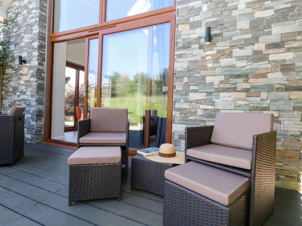 An outdoor seating area with chairs and a table at Shepherd Oak in Upwey near Weymouth