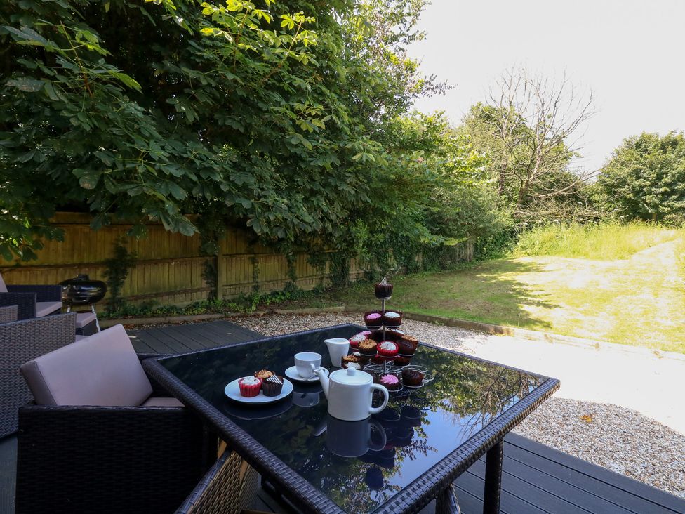 An outdoor table set with cupcakes and tea at Shepherd Oak in Upwey near Weymouth