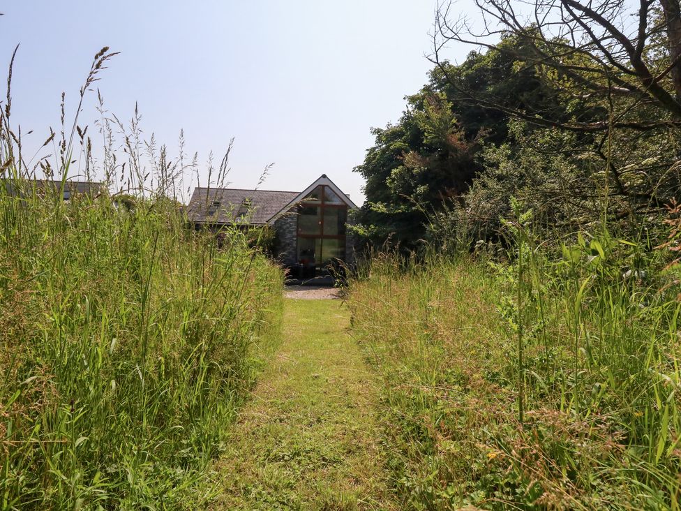 A pathway leading to a house surrounded by grass at Shepherd Oak in Upwey near Weymouth
