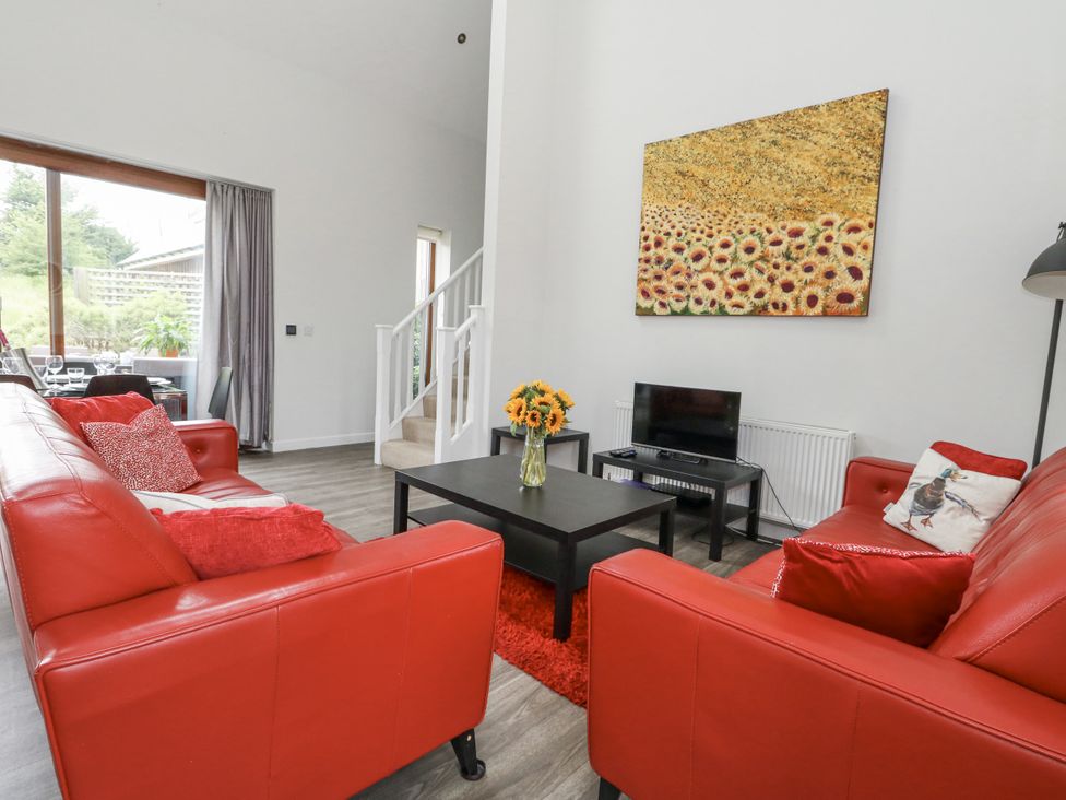 A living room with a sofa and television at Everdene Upwey near Weymouth