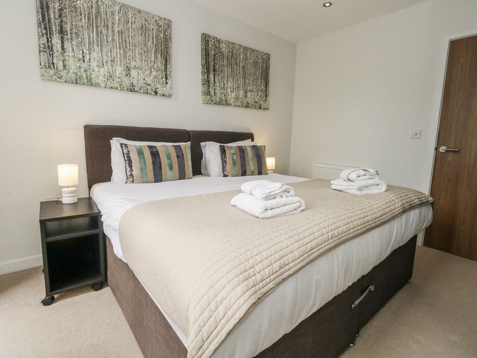 A bedroom with a double bed and bedside table at Everdene near Weymouth