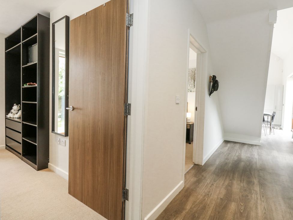 A hallway with a door and a shelf at Everdene in Upwey near Weymouth