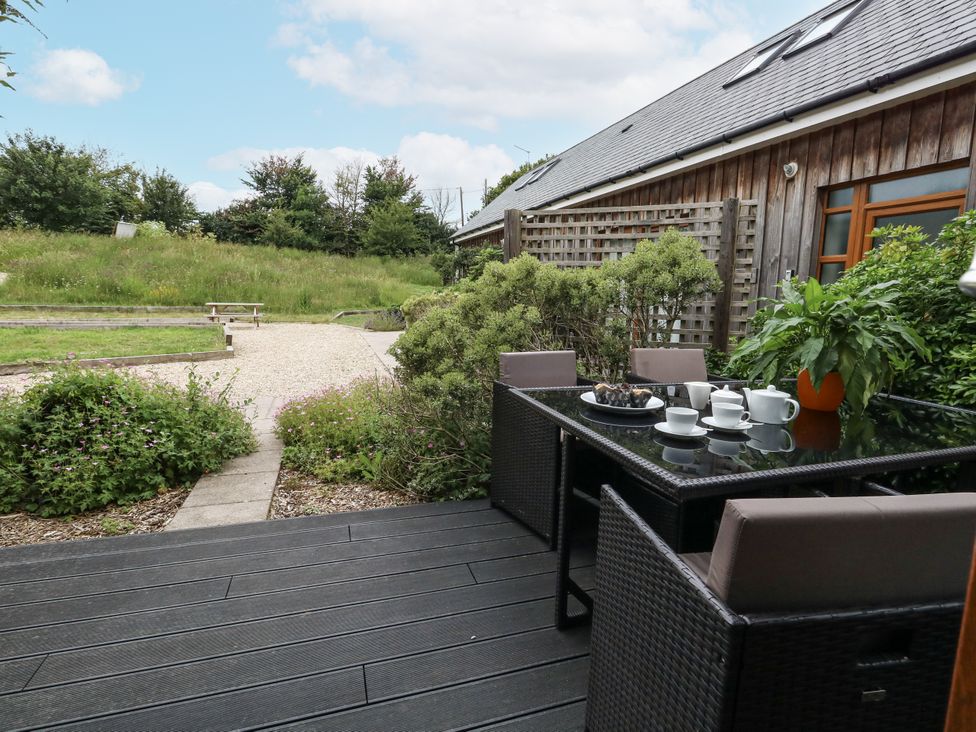 An outdoor seating area with a table and chairs at Everdene in Upwey near Weymouth