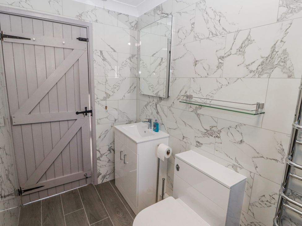 A bathroom with a sink and toilet at Corner Cottage in Broad Haven