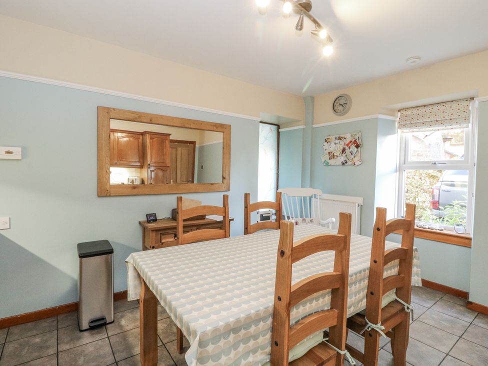 A dining room with a table and chairs at Deskford Cottage in Nairn
