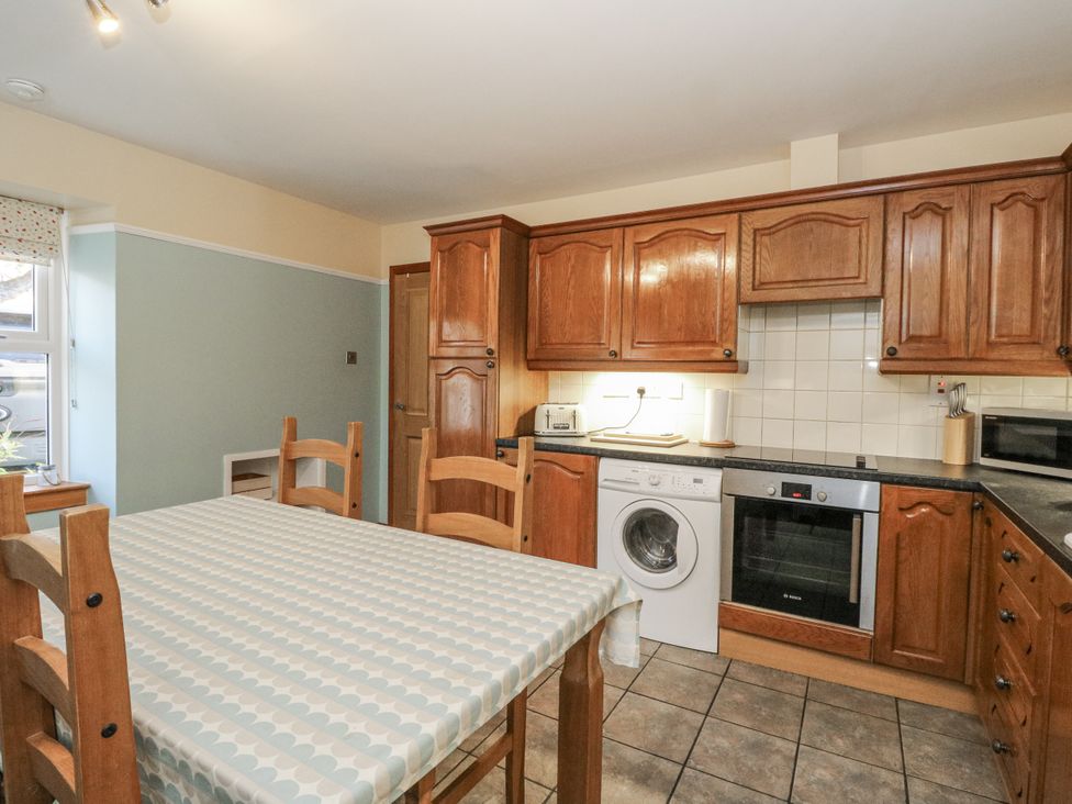 A kitchen with a table and chairs at Deskford Cottage in Nairn