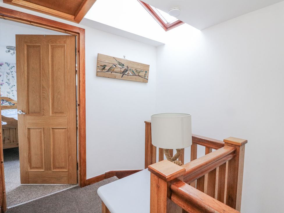A hallway with a door and lamp at Deskford Cottage in Nairn