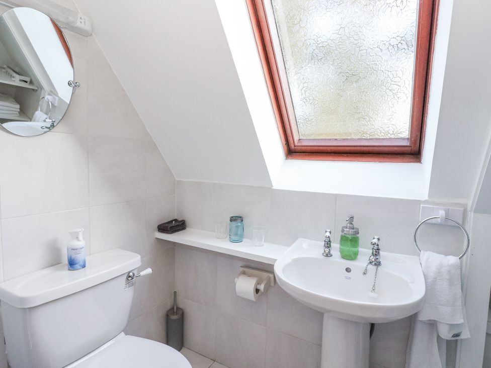 A bathroom with a toilet and sink at Deskford Cottage in Nairn