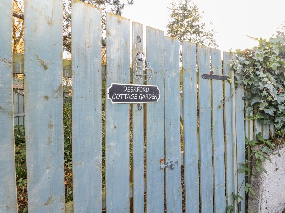 A garden gate with a sign at Deskford Cottage in Nairn