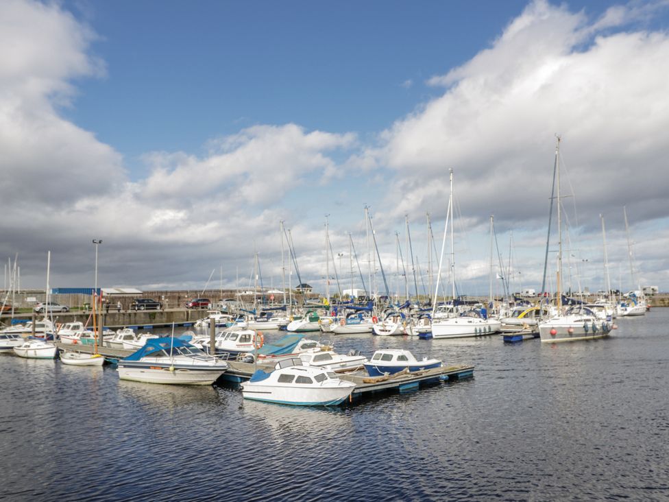 A marina with boats docked at Deskford Cottage in Nairn