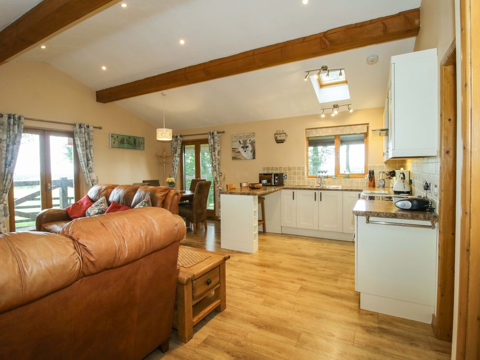A kitchen with a sofa and coffee table at Valley View Lodge Welshpool